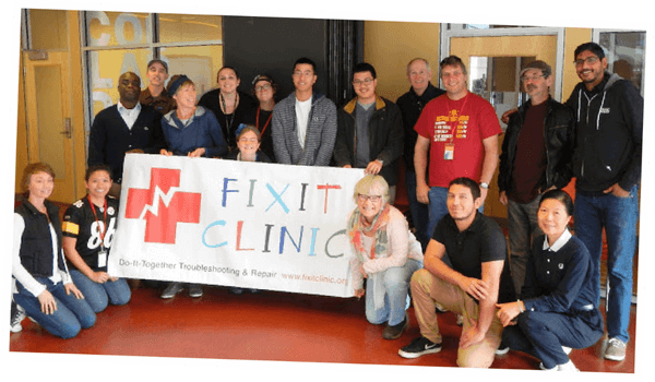 Image: A group of people holding Fix-It Clinic sign